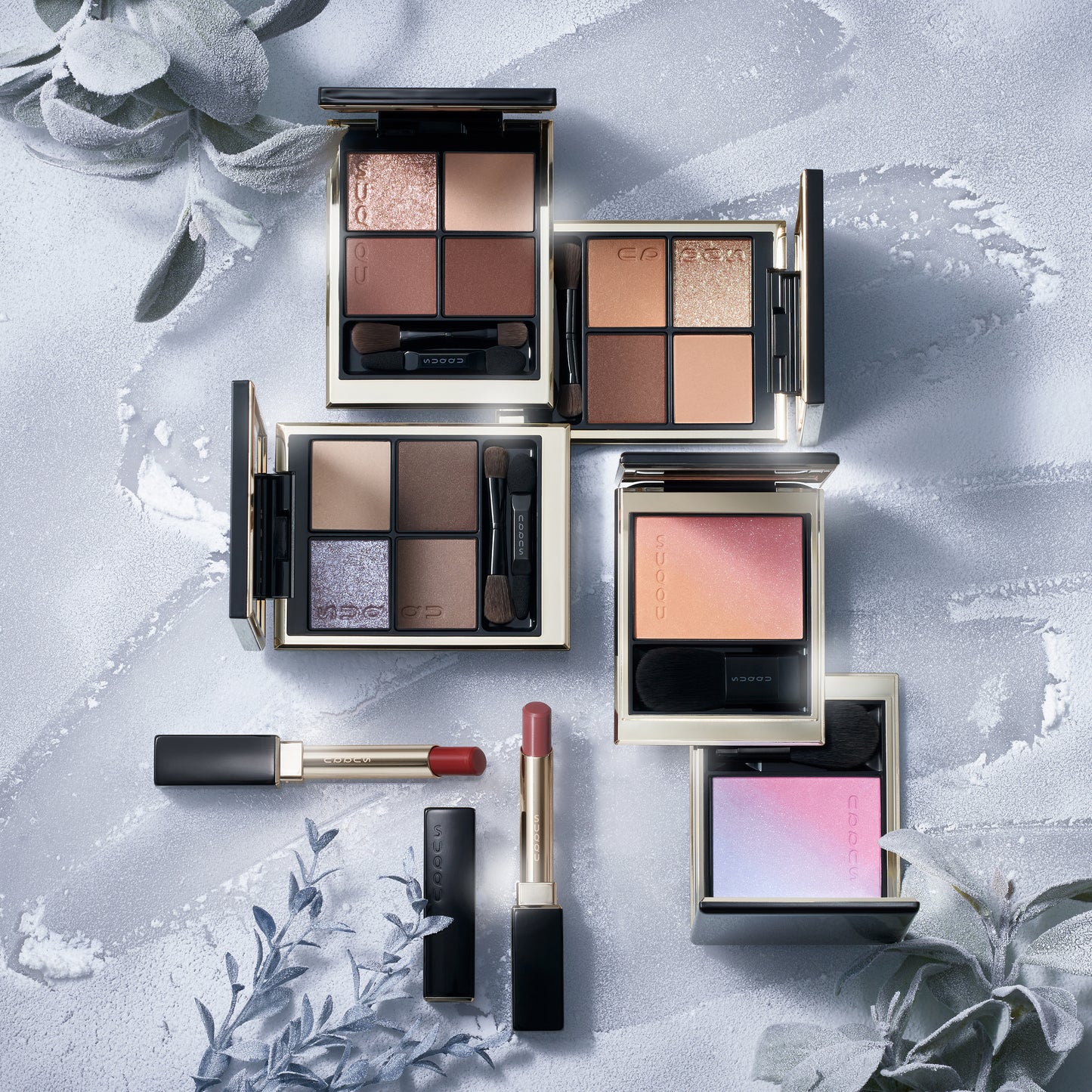 SUQQU Winter Collection 2025 eyeshadow, lipstick and blushers on frosted background.