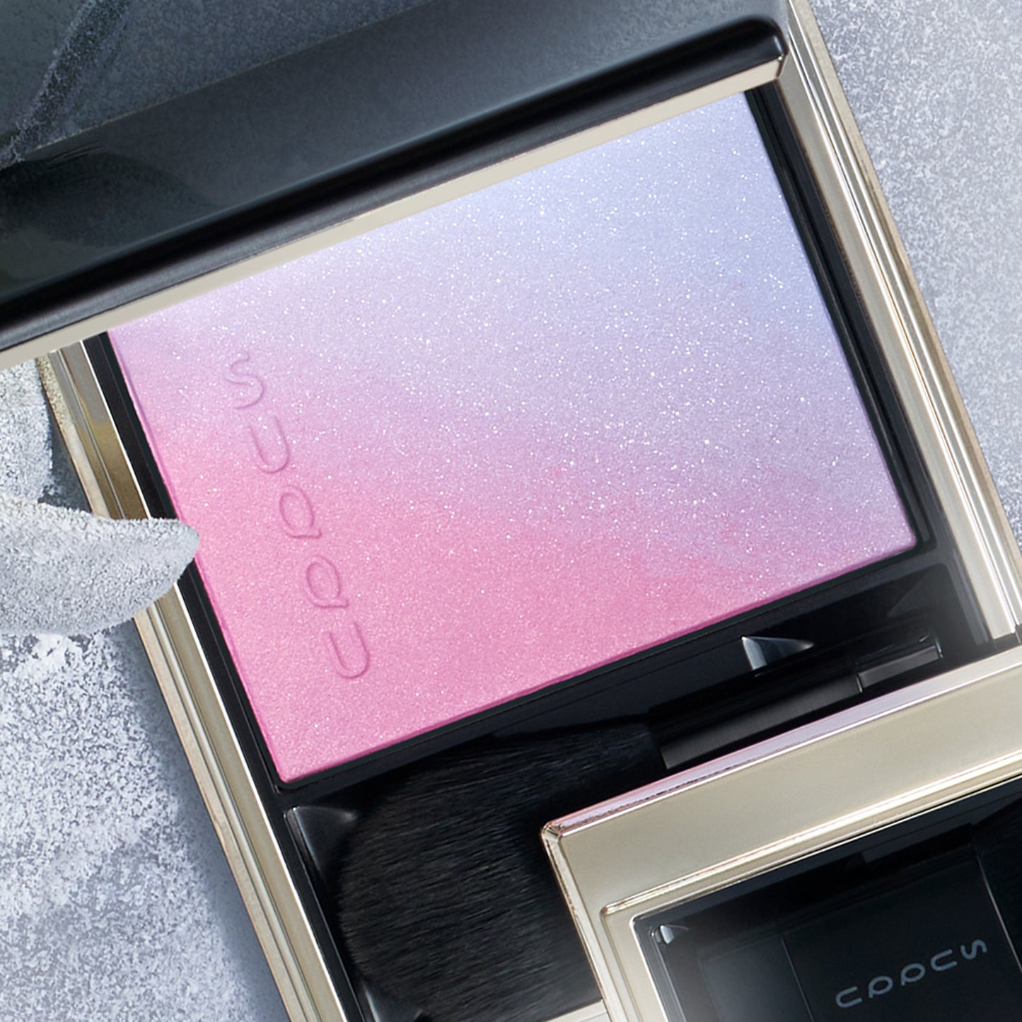 SUQQU Winter Collection 2025 Blurring Color Blush 113 pink blue toned cheek blusher and highlighter palette open on frosted background.