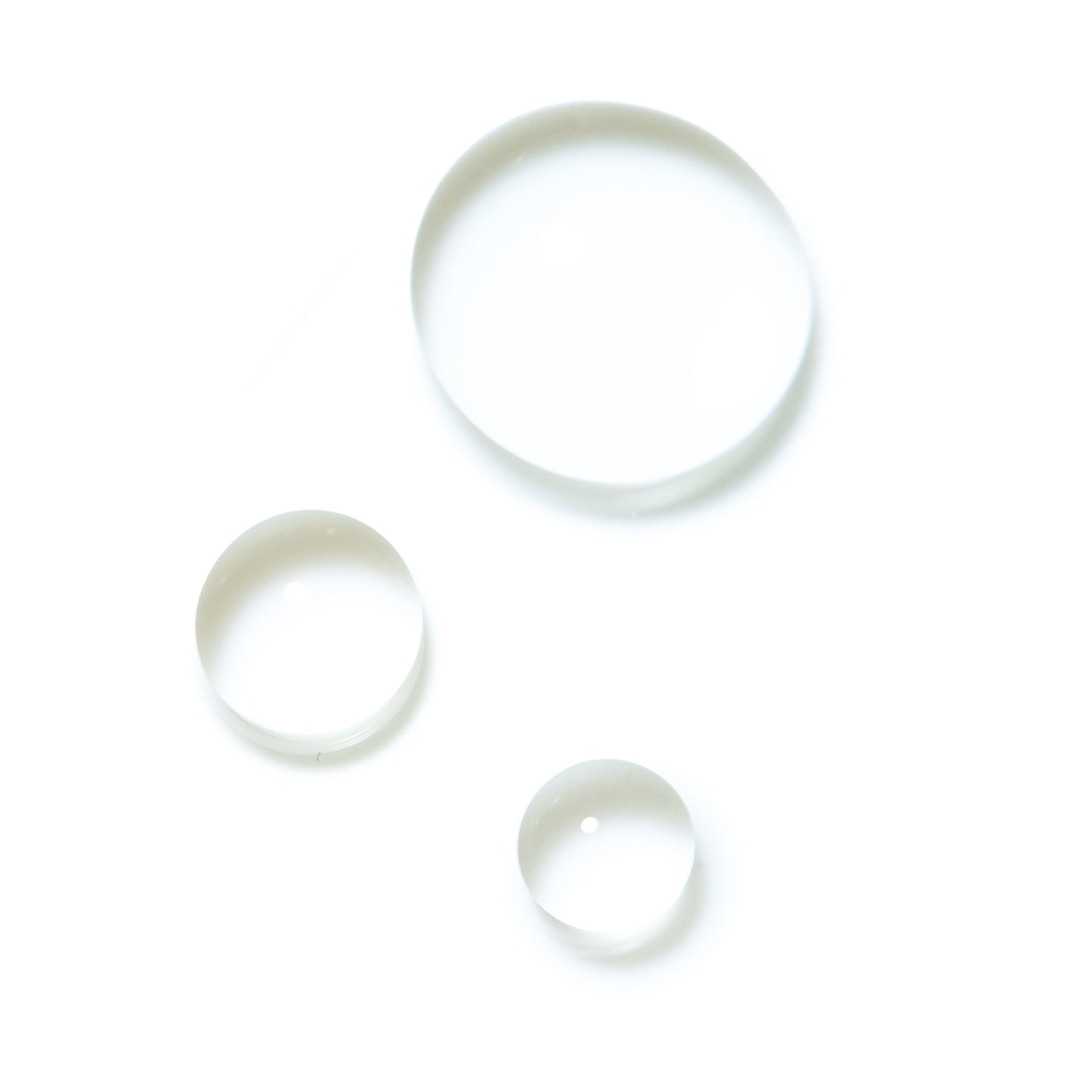 SUQQU Clarifying Toner skincare product liquid texture swatches on plain background.