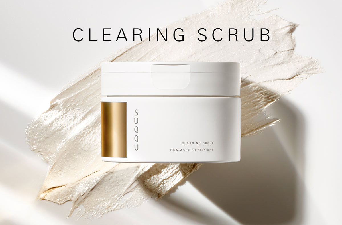 SUQQU Clearing Scrub face cleanser tub with texture swatch background