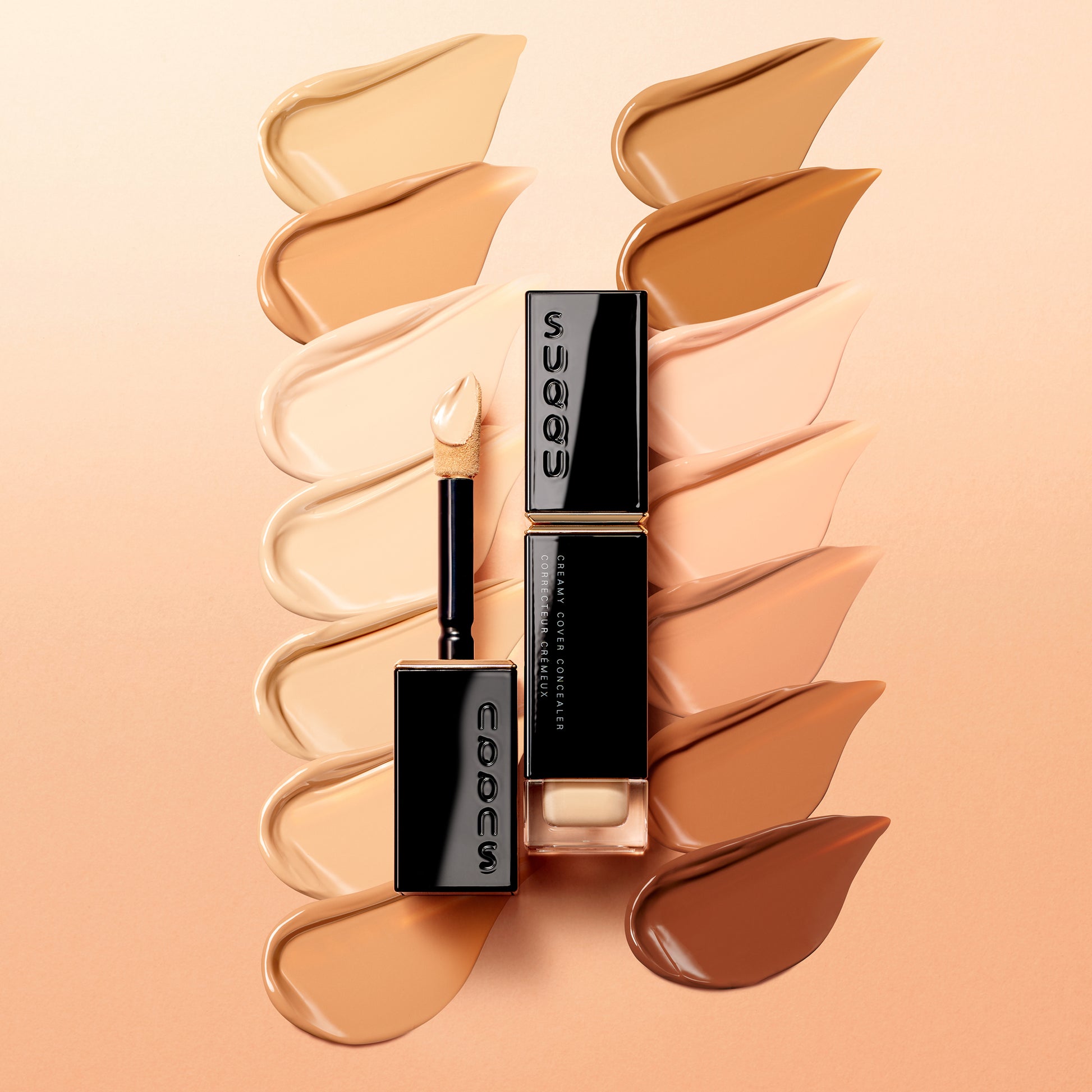 SUQQU Creamy Cover Concealer product with texture swatch background.