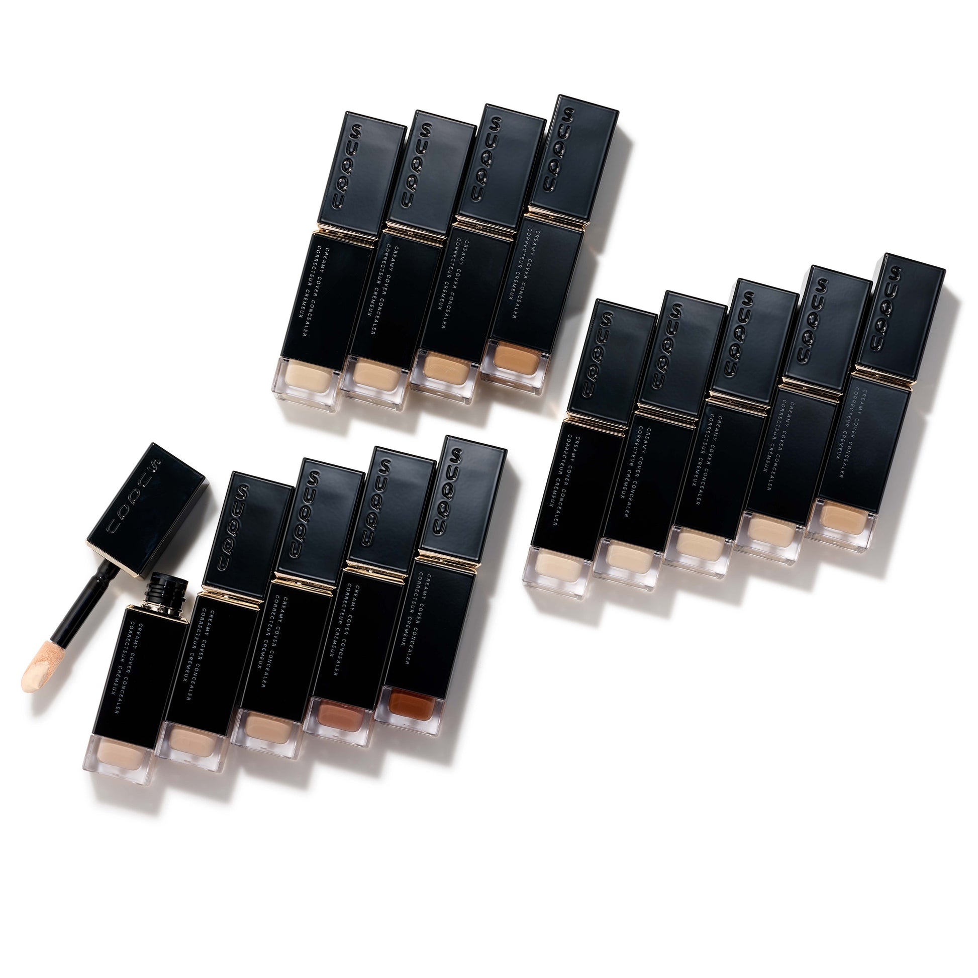 Multiple SUQQU Creamy Cover Concealer products on a table.