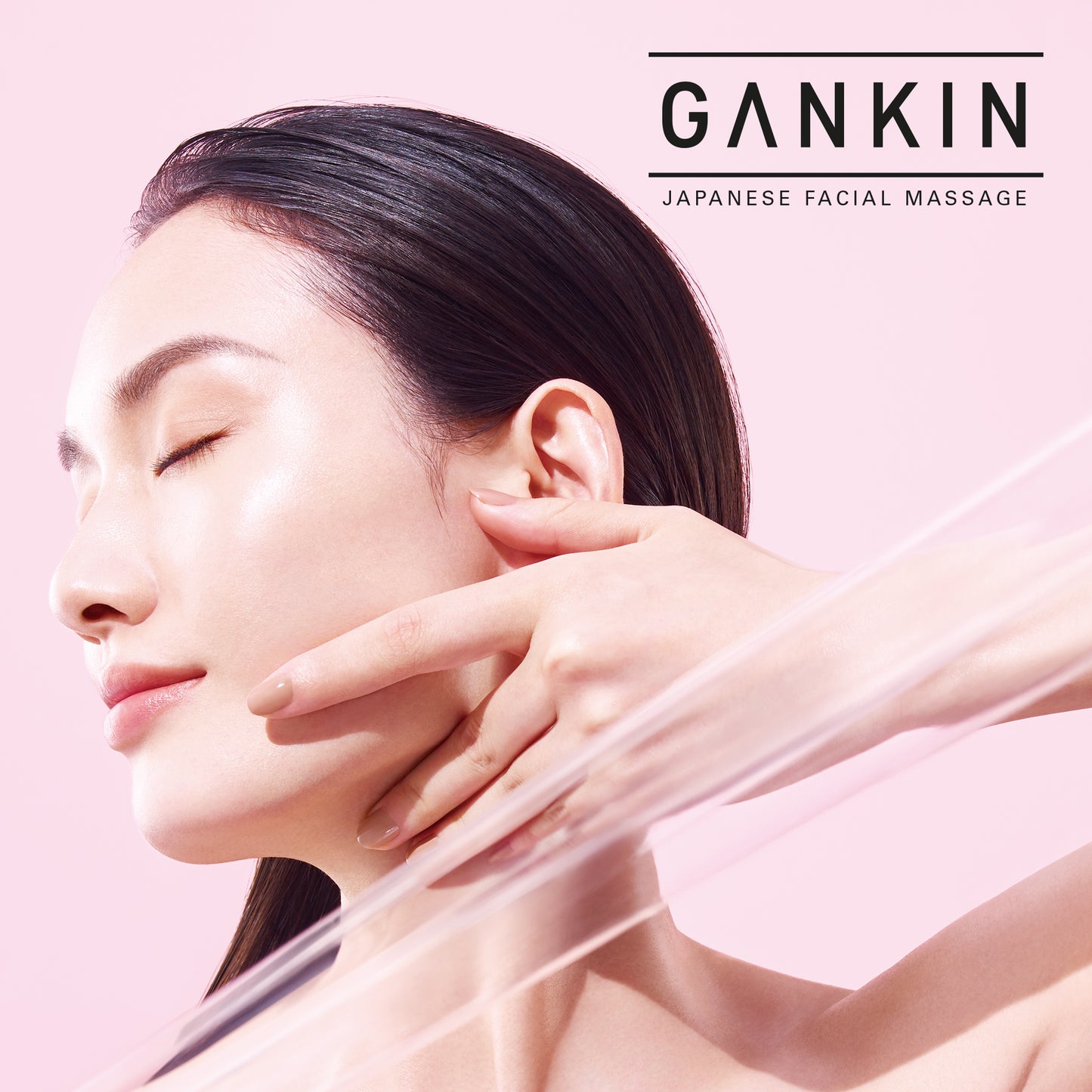 SUQQU GANKIN Japanese facial massage model portrait performing massage step with hand on jaw line.