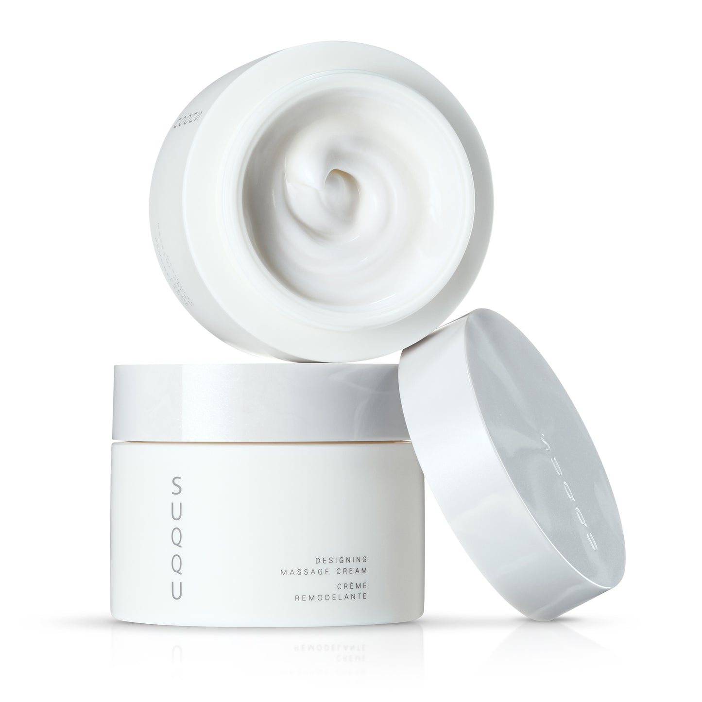 Two stacked SUQQU Designing Massage Cream Japanese luxury skincare tubs on plain background with lid off.