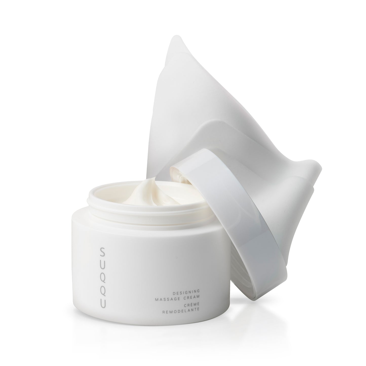 SUQQU Designing Massage Cream skincare product tub on plain background with cleansing cloth.