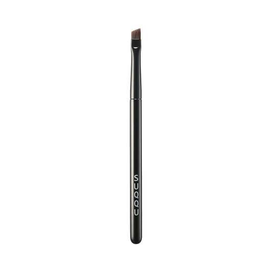 SUQQU Eyebrow Brush Small Japanese synthetic artisan professional grade make up brush on plain background.