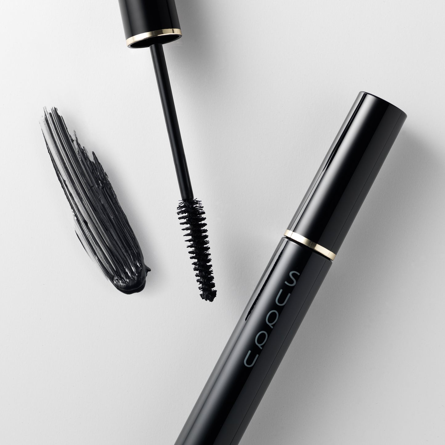 SUQQU Eyelash Mascara Black eye make up product with open brush and texture and cap on.
