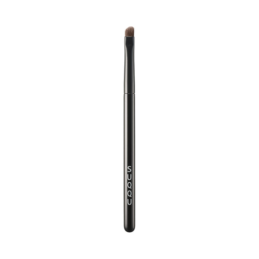 SUQQU Eyeliner Brush N Japanese synthetic artisan professional grade make up brush on plain background.