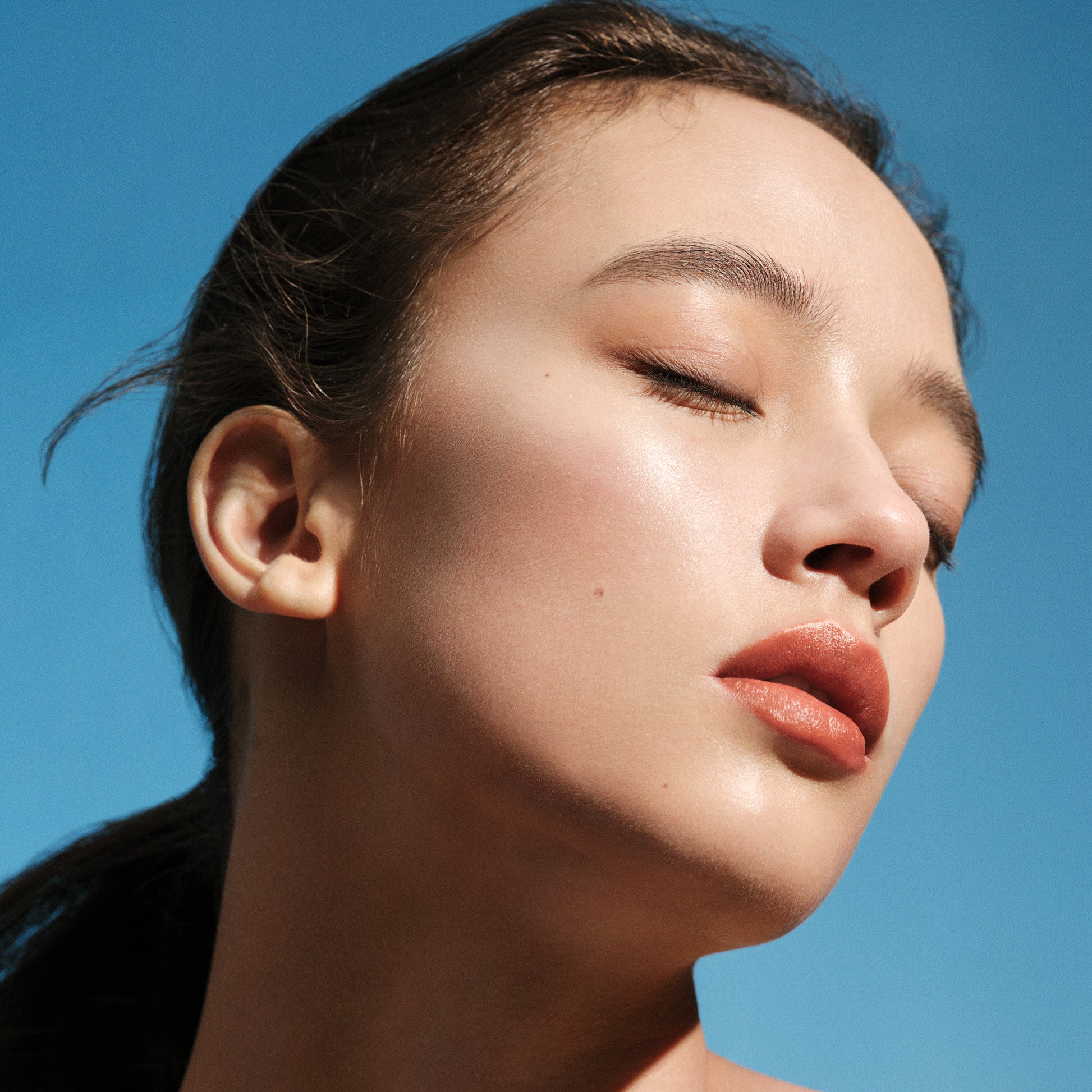 Model showing glow setting powder on cheek