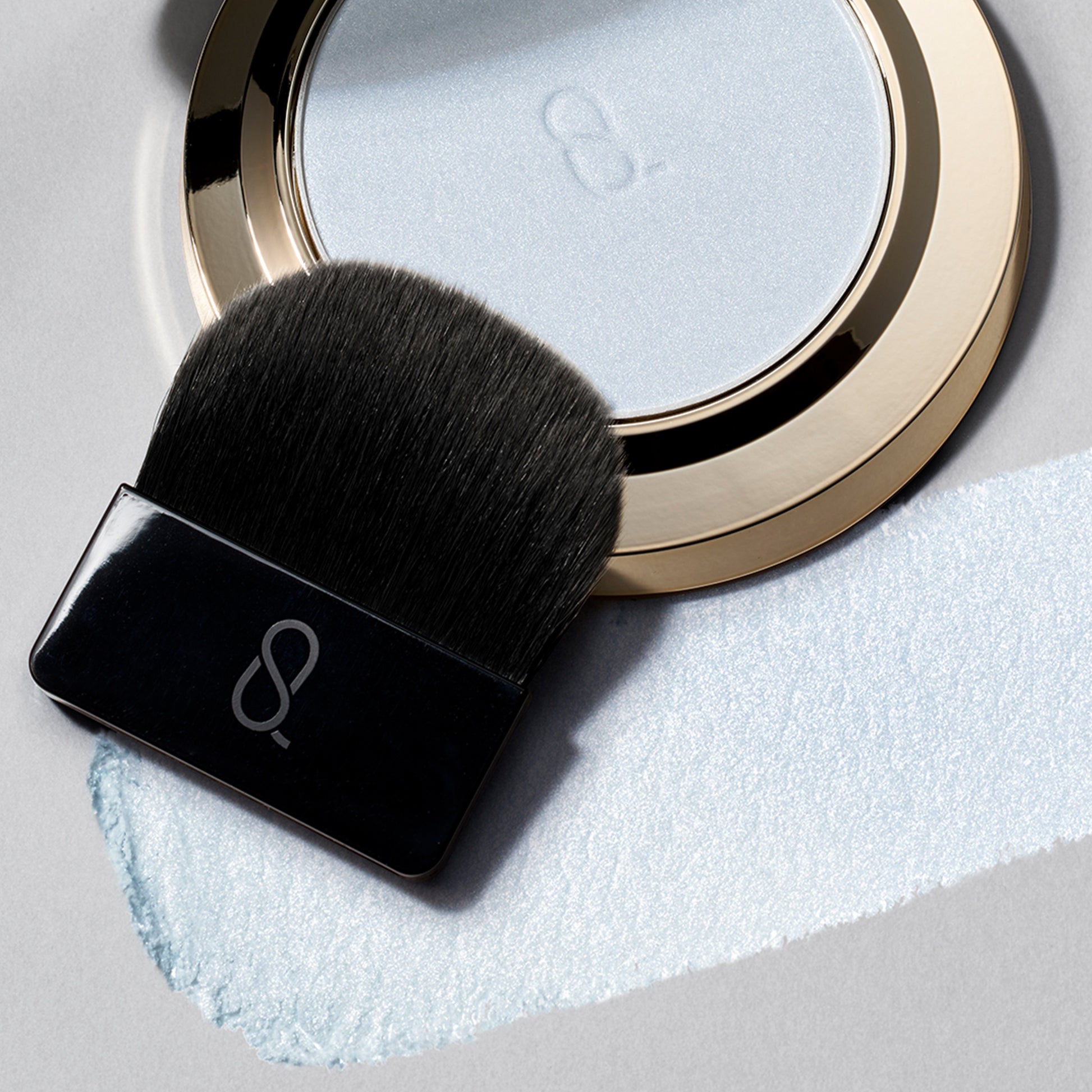 SUQQU Glow Setting Powder palette with brush and texture.