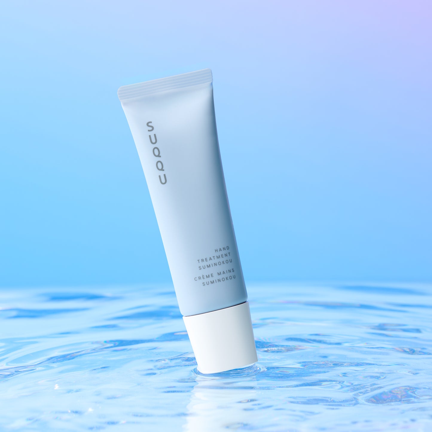 SUQQU Hand Treatment Suminokou Japanese scented moisturising hand cream on water ripple background.