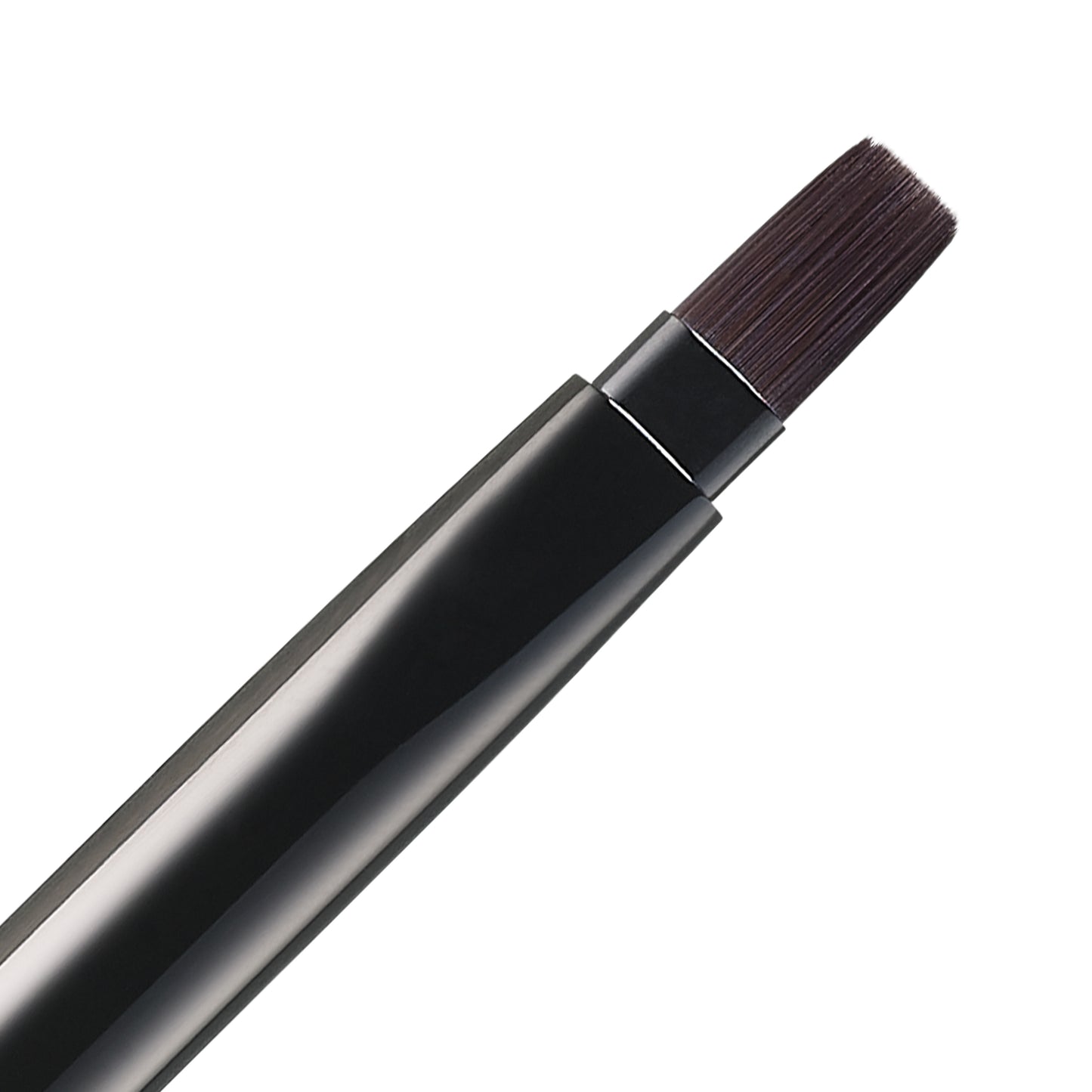 SUQQU Lip Brush Japanese synthetic artisan make up brush bristle close up on plain background.