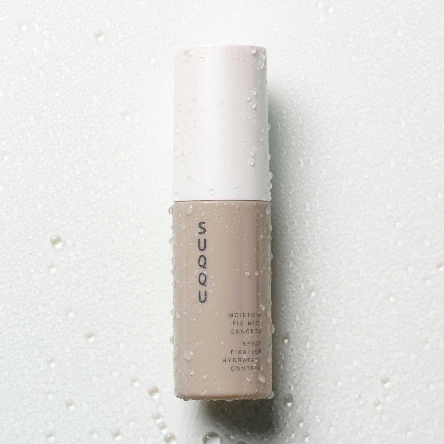 SUQQU Makeup Fix Mist Onnokou Japanese scented moisturising make up fix spray on water droplet background.