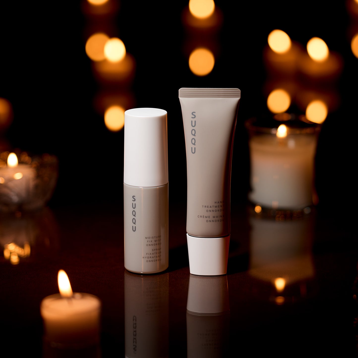 SUQQU Makeup Fix Mist & Hand Treatment Onnokou Japanese scented moisturising products on dark background.