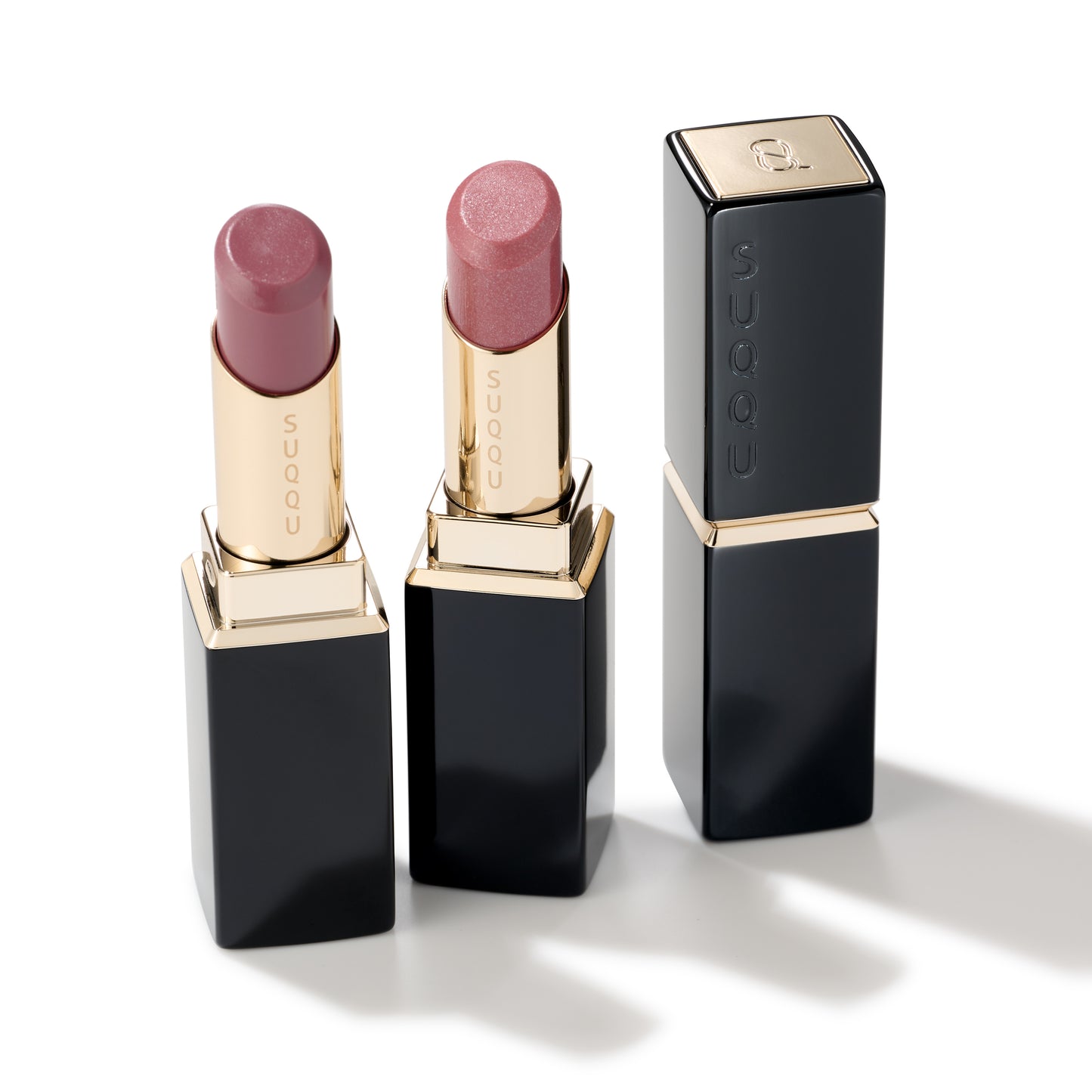 Two beautiful SUQQU Moisture Glaze Lipsticks in shades 13 and 109 open and shown with a single case close