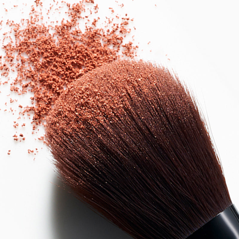 Close up of make up brush with make up powder