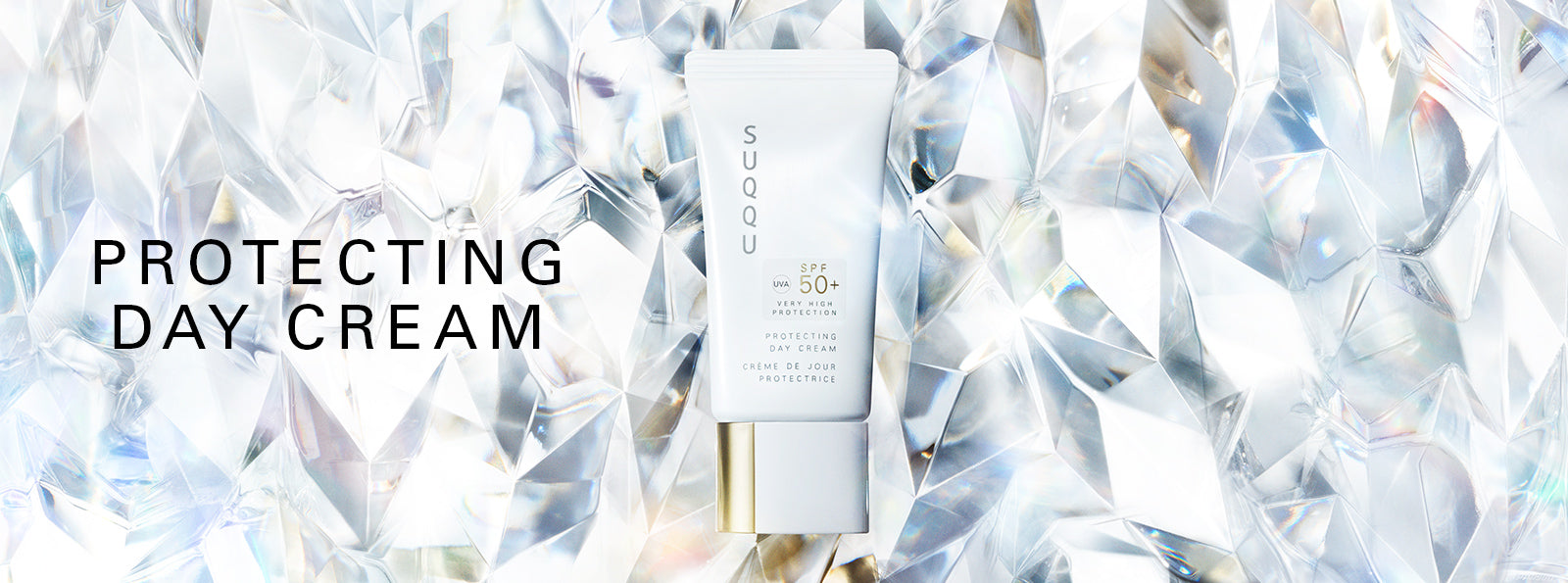 SUQQU Protecting Day Cream Japanese best luxury sunscreen SPF 50+ with moisturising skincare for face. UV-A, UV-B protecting skincare and base makeup product tube on crystal background.