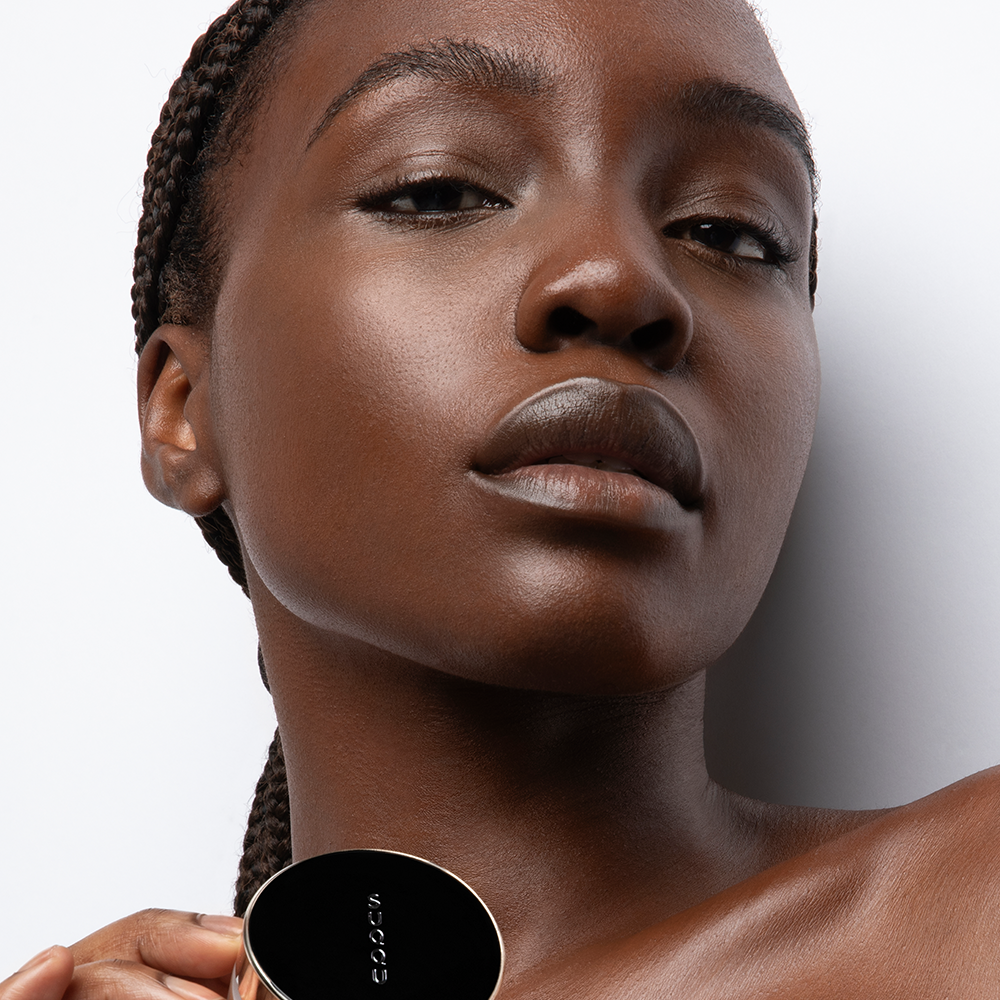 Model portrait holding foundation pot