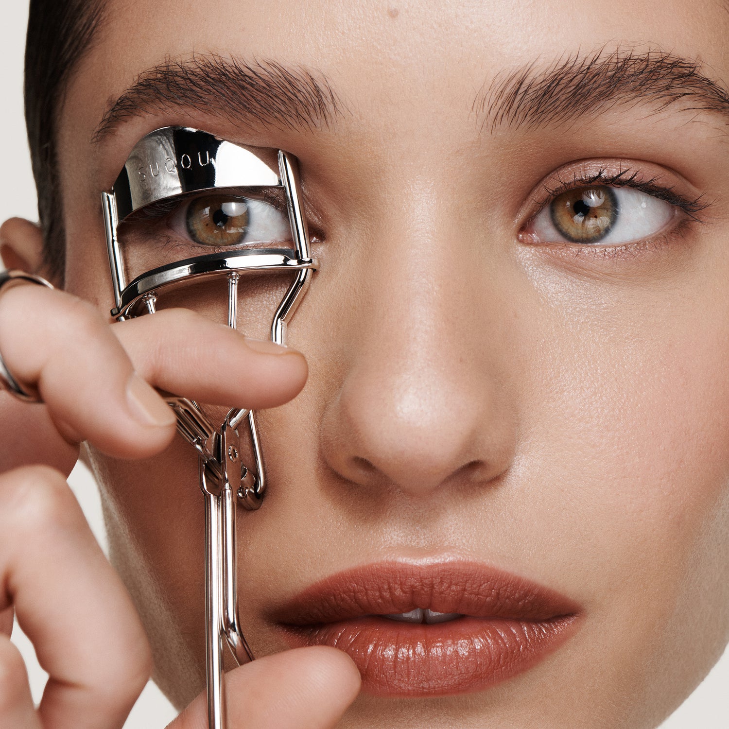 Model close up with eyelash curler