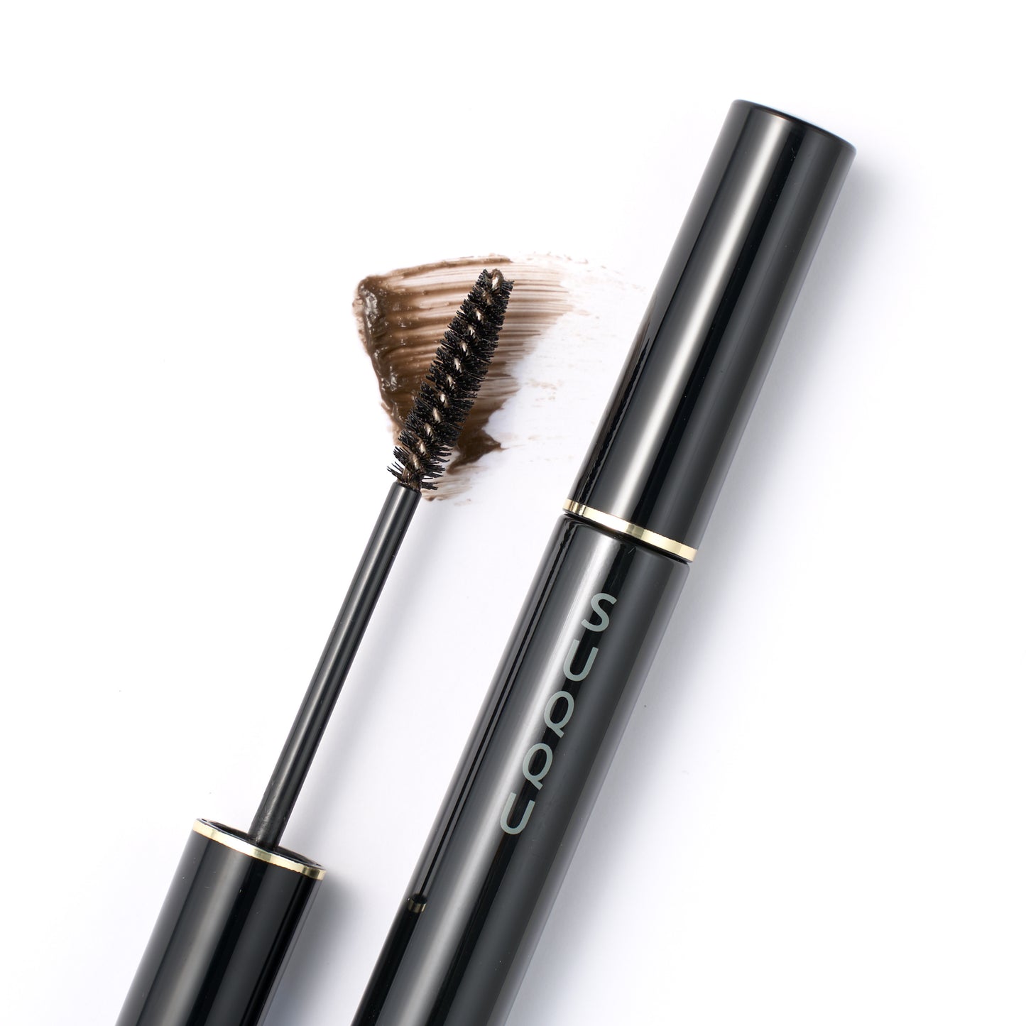 SUQQU Setting Eyebrow Gel clear brown make up product with wand open on colour swatch and cap closed.