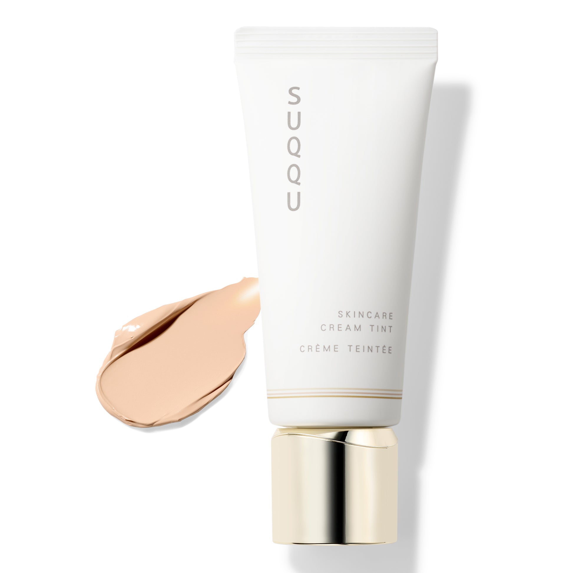 SUQQU Skincare Cream Tint foundation tube with swatch texture on a plain background.