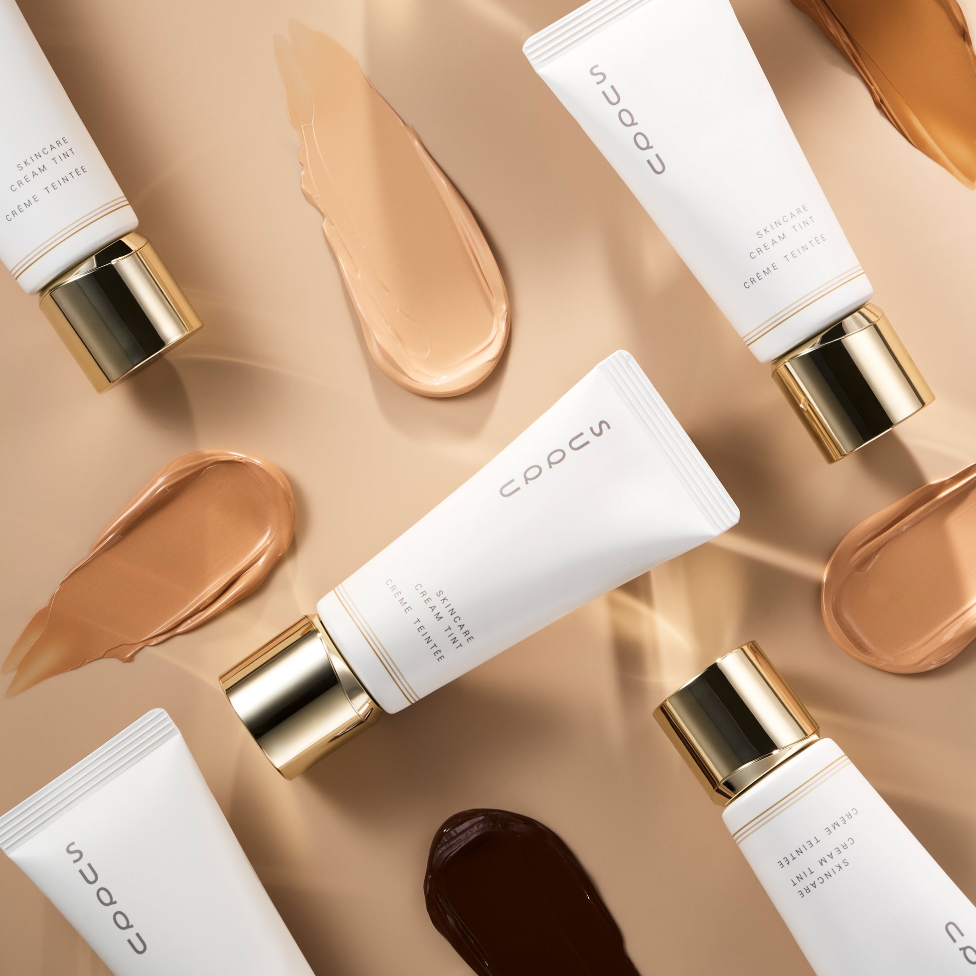 Five SUQQU Skincare Cream Tint foundation tubes with colour swatches.