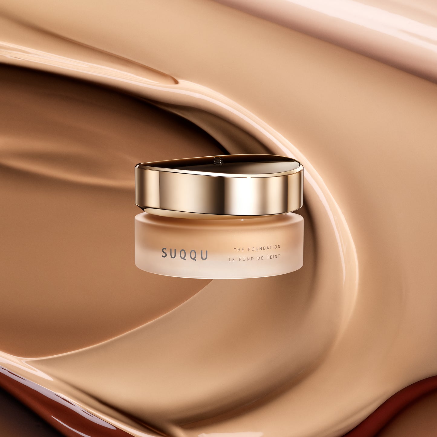 SUQQU The Foundation luxury moisturising Japanese cream base make up jar on texture background.