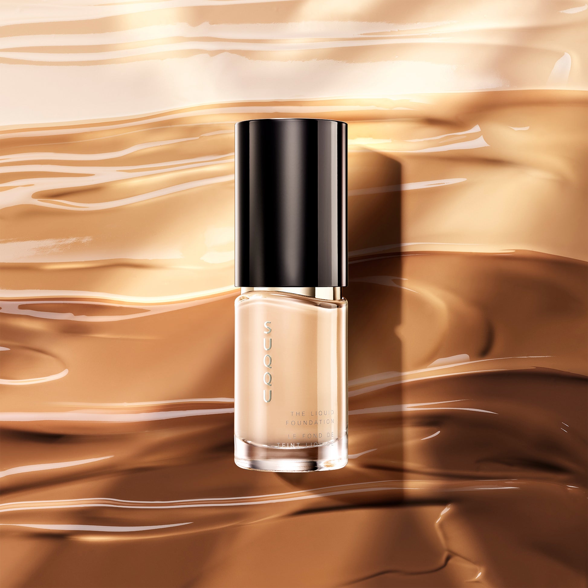 SUQQU The Liquid Foundation luxury finest Japanese base make up bottle on swatch texture background.