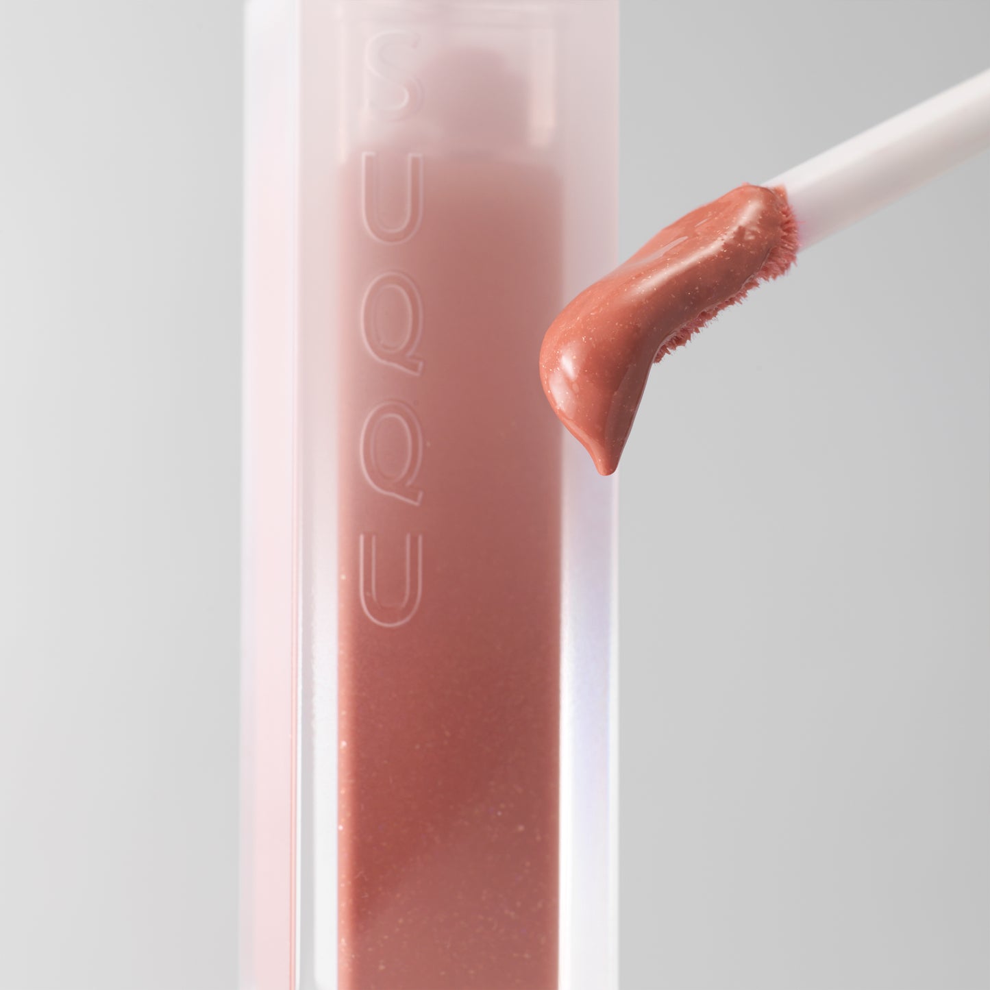 SUQQU Treatment Wrapping Lip colour product close up with wand and texture