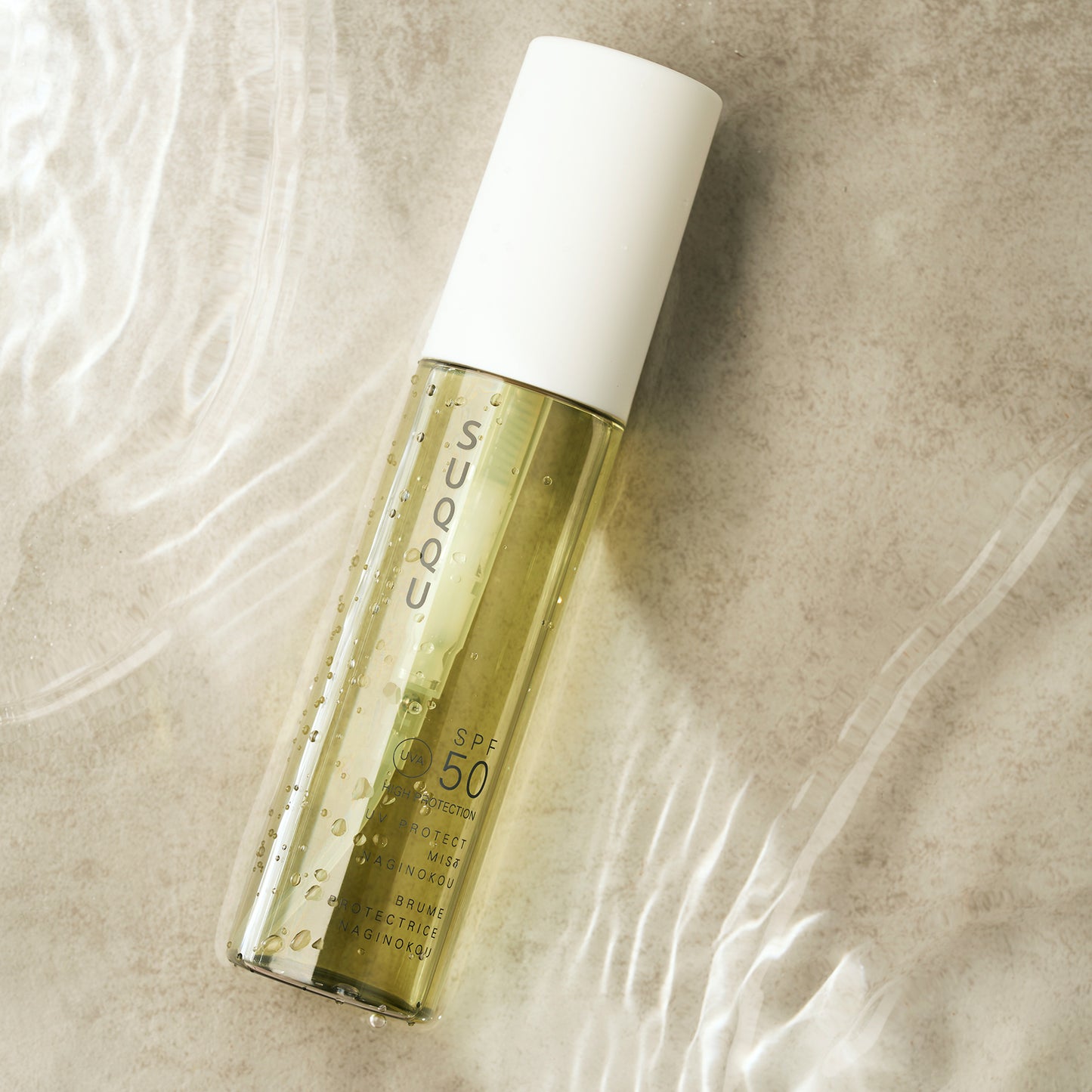 SUQQU UV Protect Mist Naginokou SPF 50 reliable Japanese premium sun care pump bottle with water ripple background.