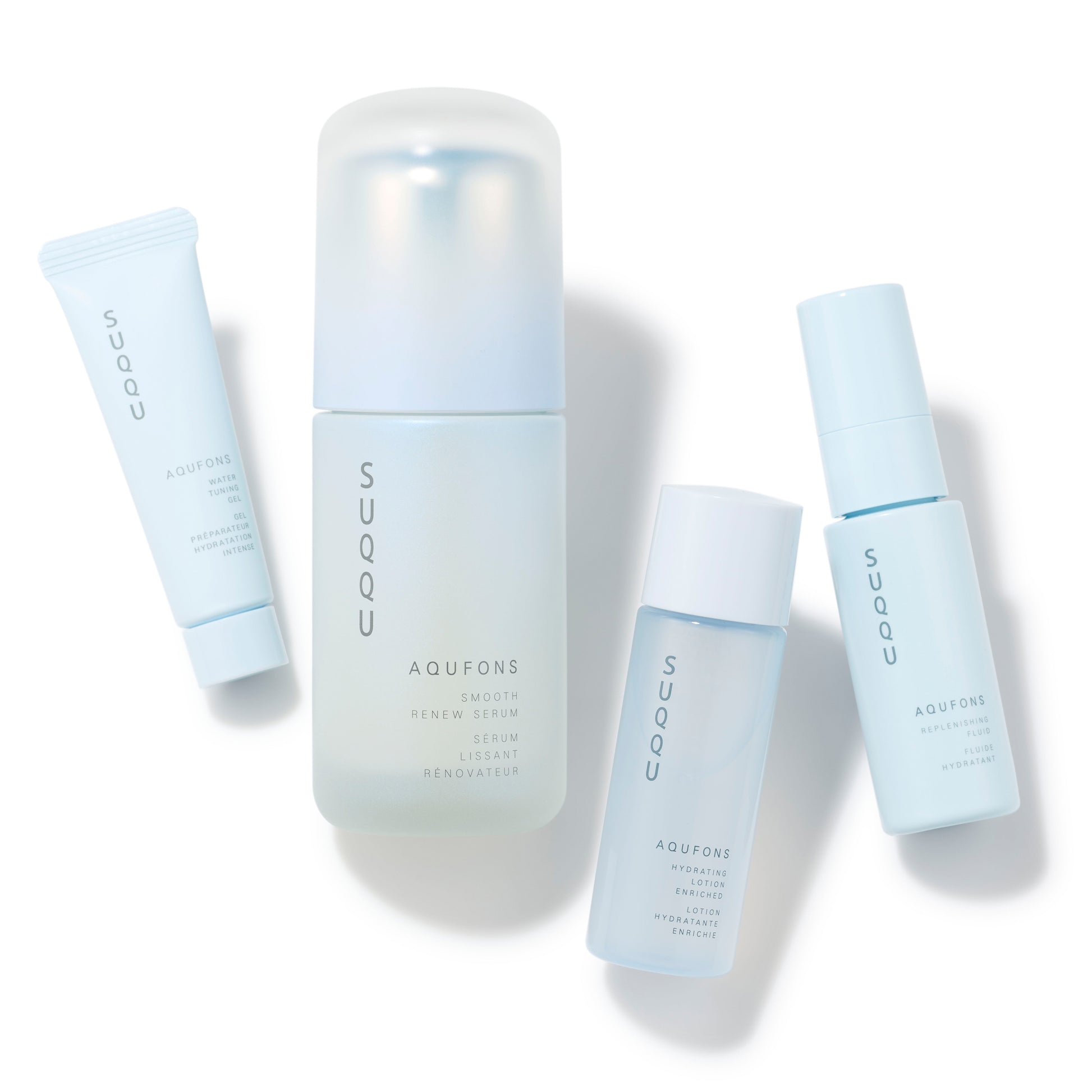 SUQQU Aqufons Smooth Renew Serum Kit four luxury Japanese skincare products on a plain background. Serum, lotion, fluid and gel moisturisers.