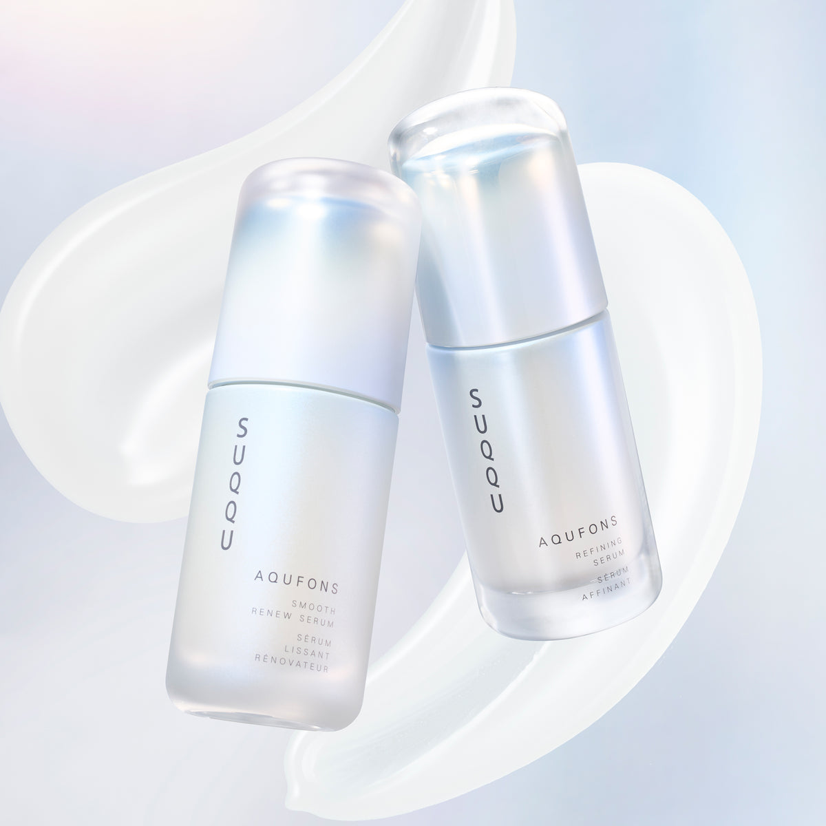 SUQQU Aqufons Smooth Renew Serum and Aqufons Refining Serum skincare moisturiser pump bottles on blue background with cream texture swatches.