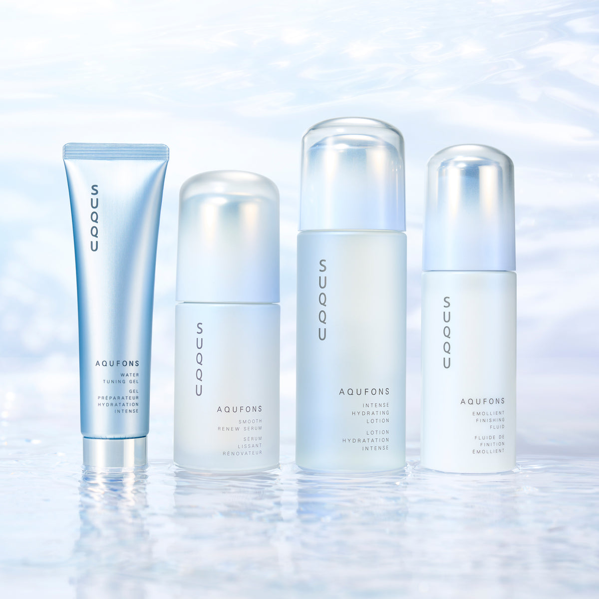 Four skincare products from SUQQU's 'Aqufons' range standing in a line on watery background. Gel, serum, lotion and fluid in pump bottles and tube.