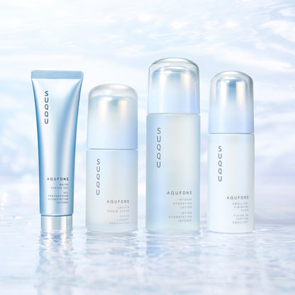 Four skincare products from SUQQU's 'Aqufons' range standing in a line on watery background. Gel, serum, lotion and fluid in pump bottles and tube.