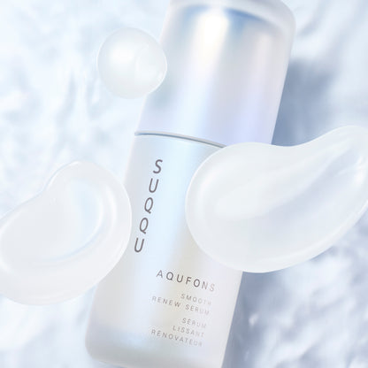 SUQQU Aqufons Smooth Renew Serum skincare face moisturiser pump bottle on blue background with luxurious cream texture swatches.