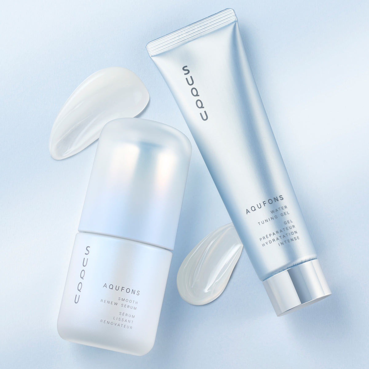 SUQQU Aqufons Smooth Renew Serum and Aqufons Water Tuning Gel skincare face moisturisers in pump bottle and tube on blue background with gel and cream texture swatches.