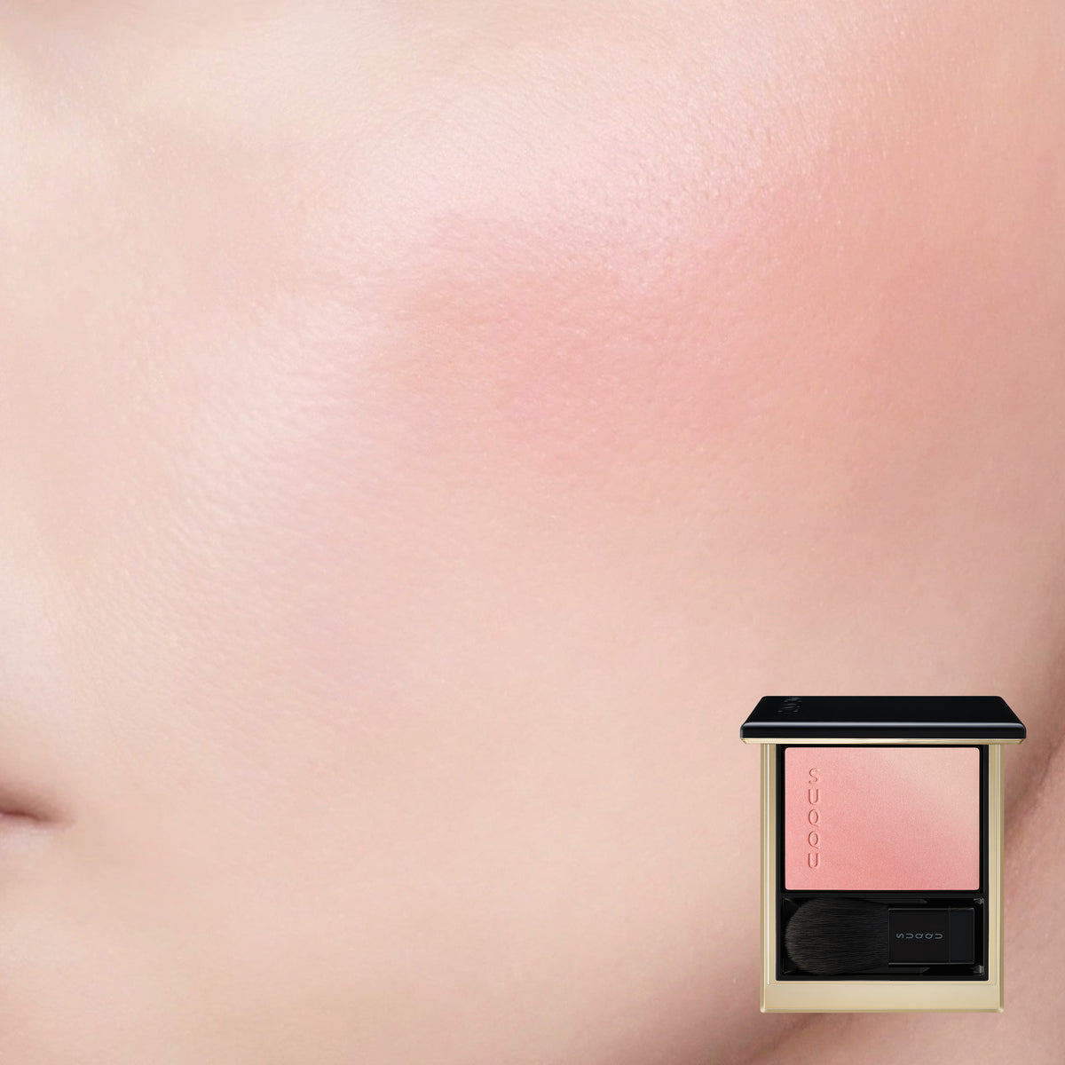 SUQQU Blurring Color Blush 119 luxury Japanese cosmetic blusher compact shown with model cheek wear close up background. Coral pink and pale beige pink highlighter shades.