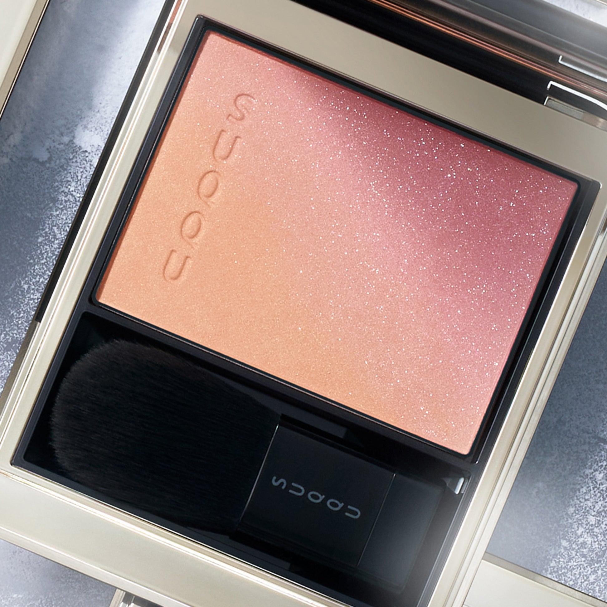 SUQQU Winter Collection 2025 Blurring Color Blush 112 pink orange toned cheek blushers palette open on frosted background.