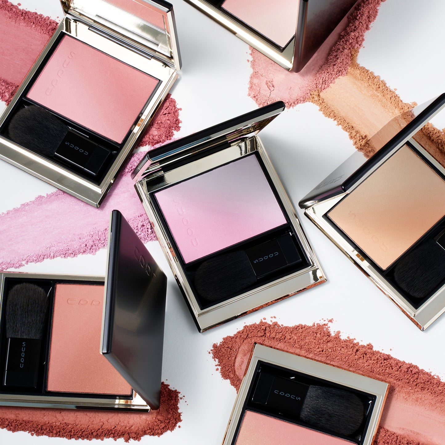 Six colourful SUQQU Blurring Color Blush palettes sitting on a table with powder swatch textures.
