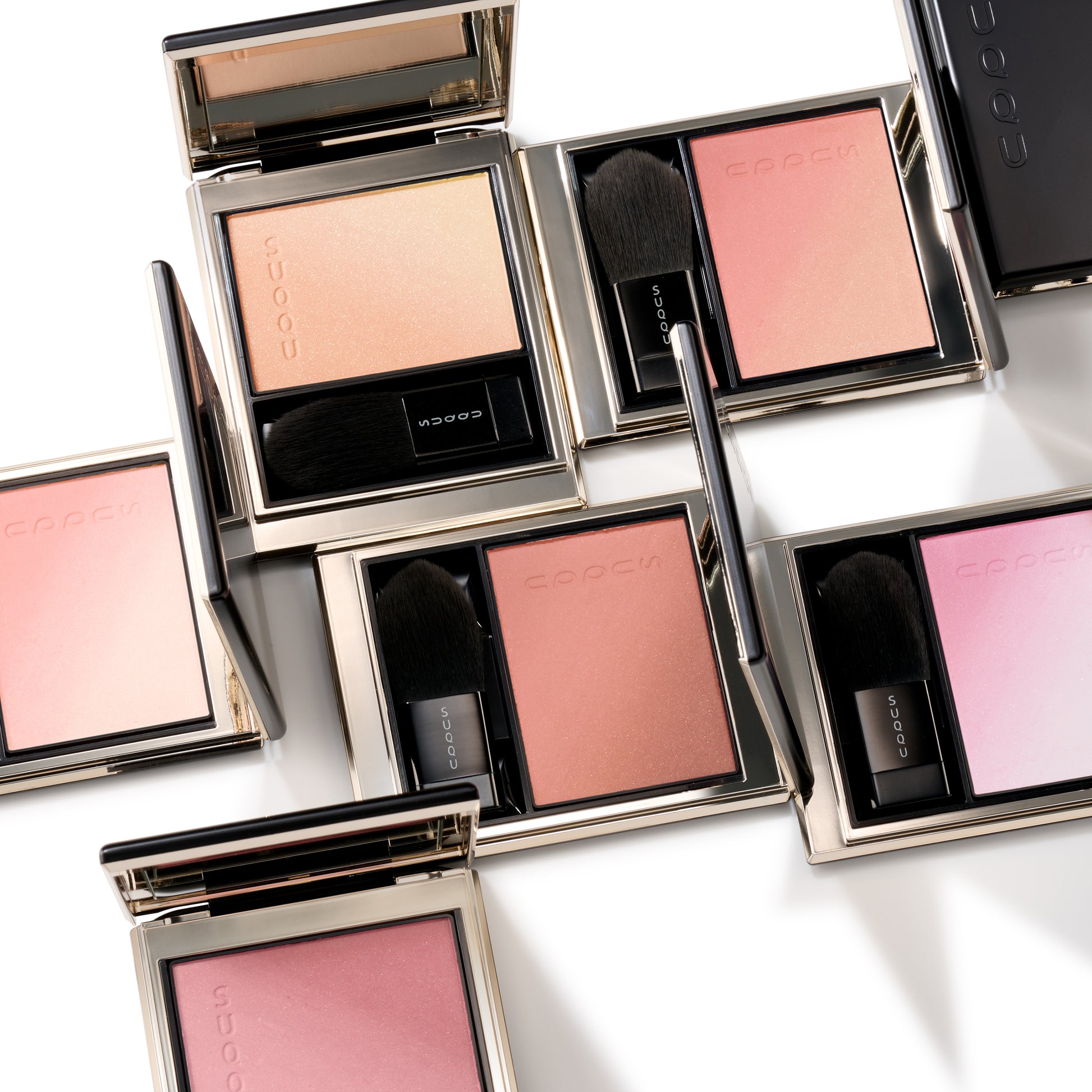 Six colourful SUQQU Blurring Color Blush palettes sitting on a table.