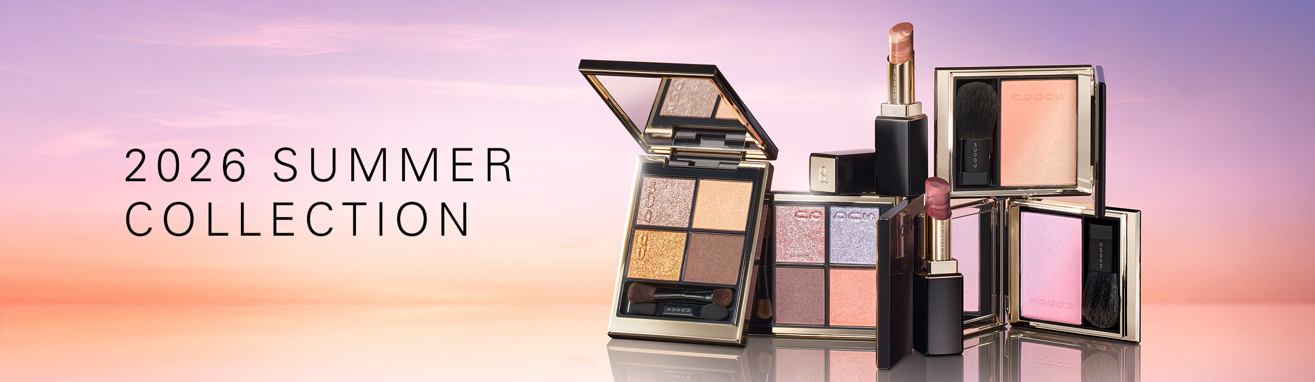 SUQQU 2026 Summer Collection, multiple beautiful colourful luxury makeup products on a gradient sky background. Two eyeshadows with gold and pink coral tones, two blushers with orange gold and lilac pink and two lipsticks in orange red and grape red.