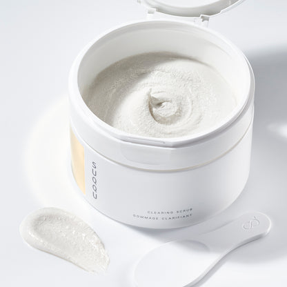 SUQQU Clearing Scrub tub open with luxurious cleansing scrub texture and spoon.