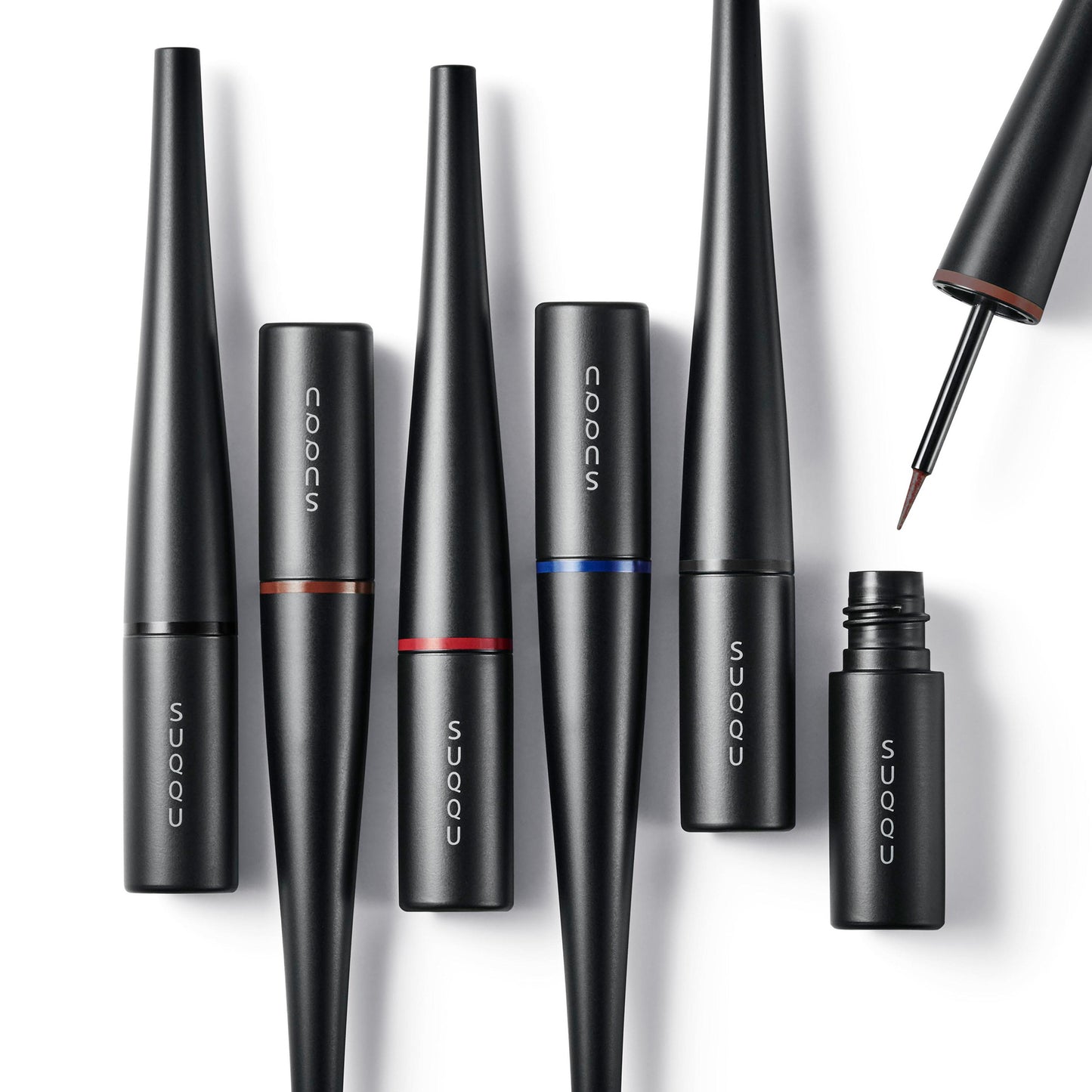 Six SUQQU Color Ink Liquid Eyeliner make up products with one cap open showing felt tip on a plain background.