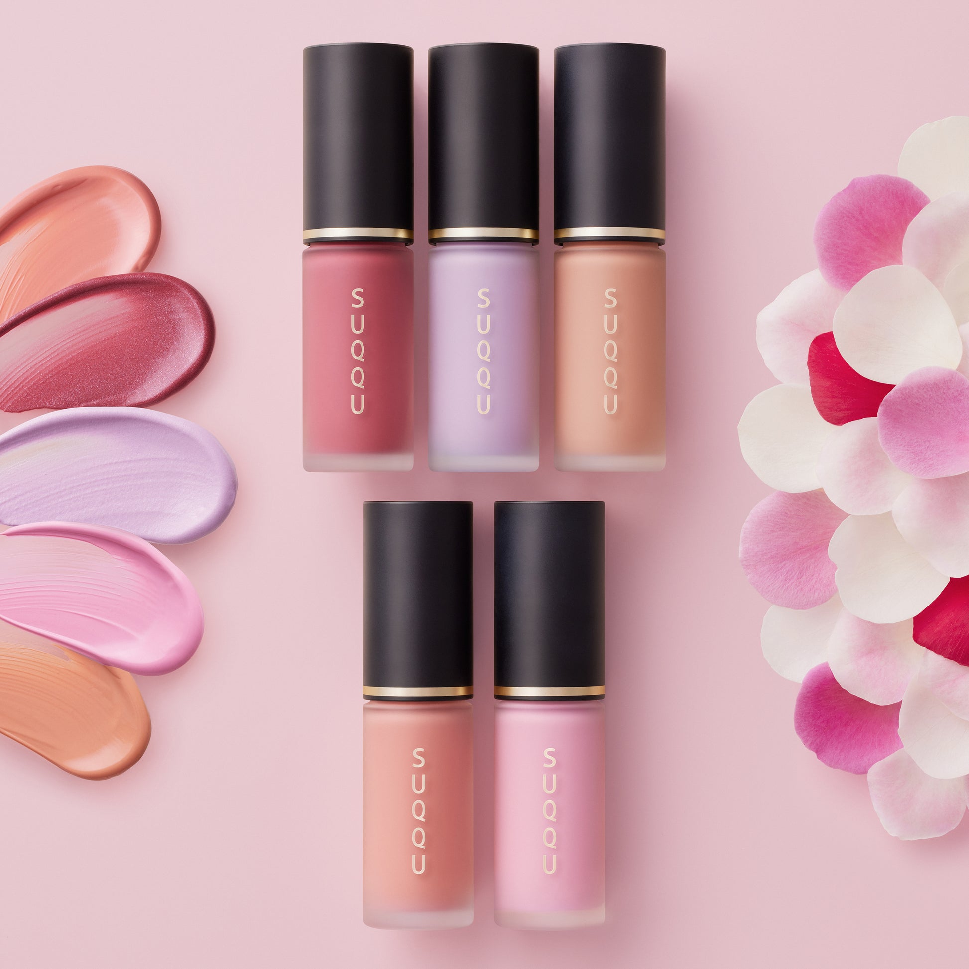 Five SUQQU Complexion Face Color products on a table with colour swatches and petals.