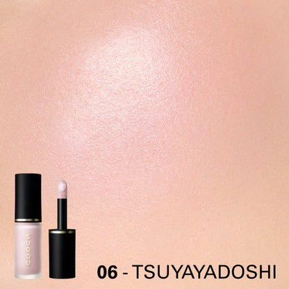 SUQQU Complexion Face Color 06 Tsuyayadoshi liquid highlighter blusher shown on model cheek close up. Glowing soft pink pearl colour.