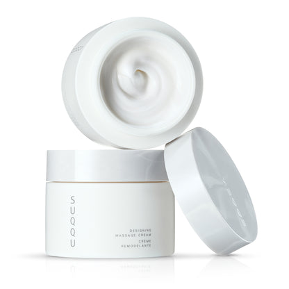 Two stacked SUQQU Designing Massage Cream Japanese luxury skincare tubs on plain background with lid off.
