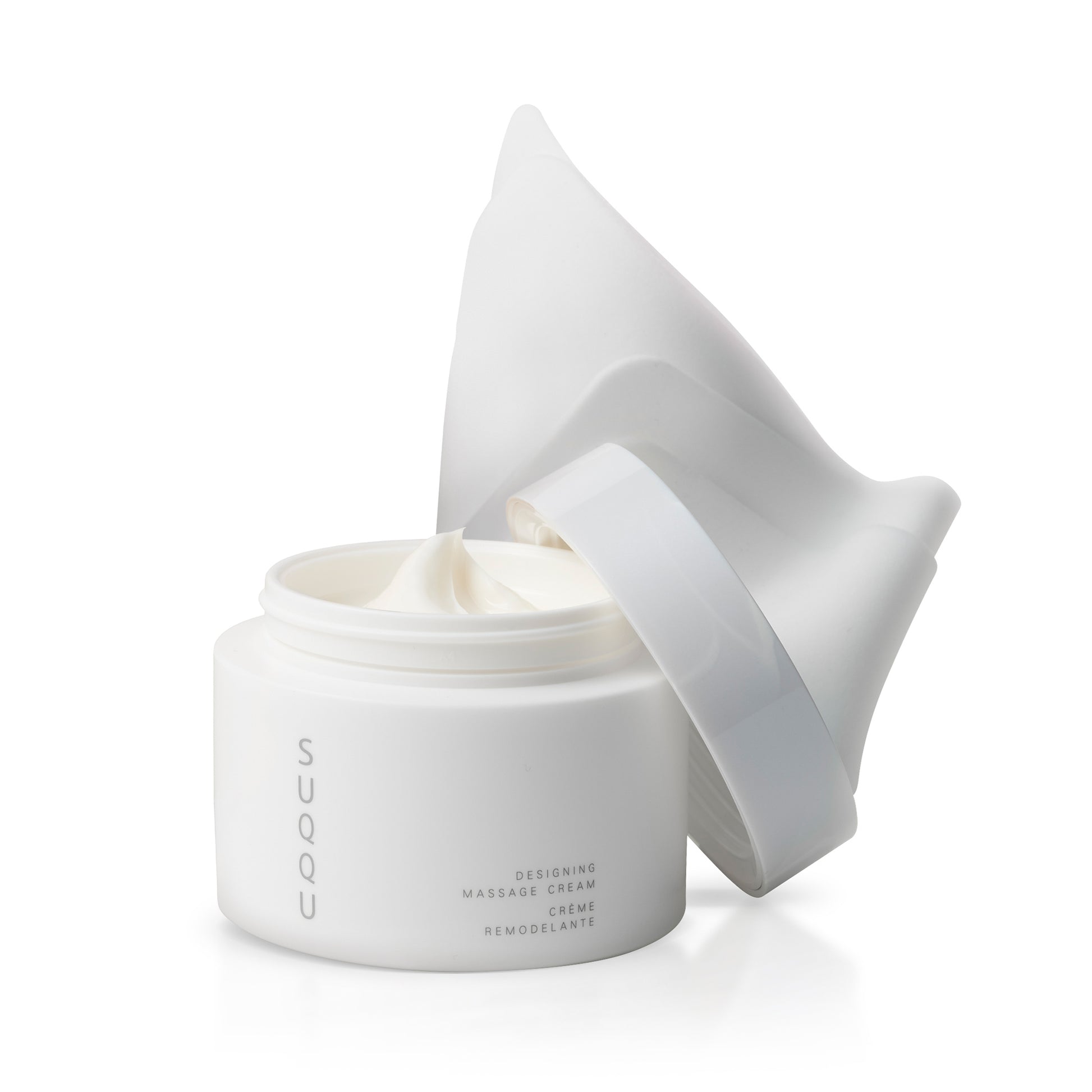 SUQQU Designing Massage Cream skincare product tub on plain background with cleansing cloth.
