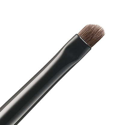 SUQQU Eyeliner Brush N Japanese synthetic artisan professional grade make up brush bristle close up on plain background.