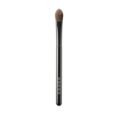 SUQQU Eyeshadow Brush F Large Japanese synthetic artisan professional grade make up brush on plain background.