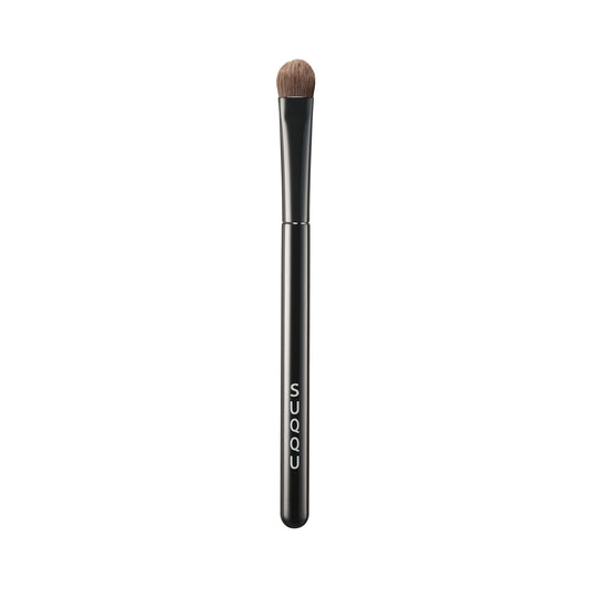 SUQQU Eyeshadow Brush F Small Japanese synthetic artisan professional grade make up brush on plain background.